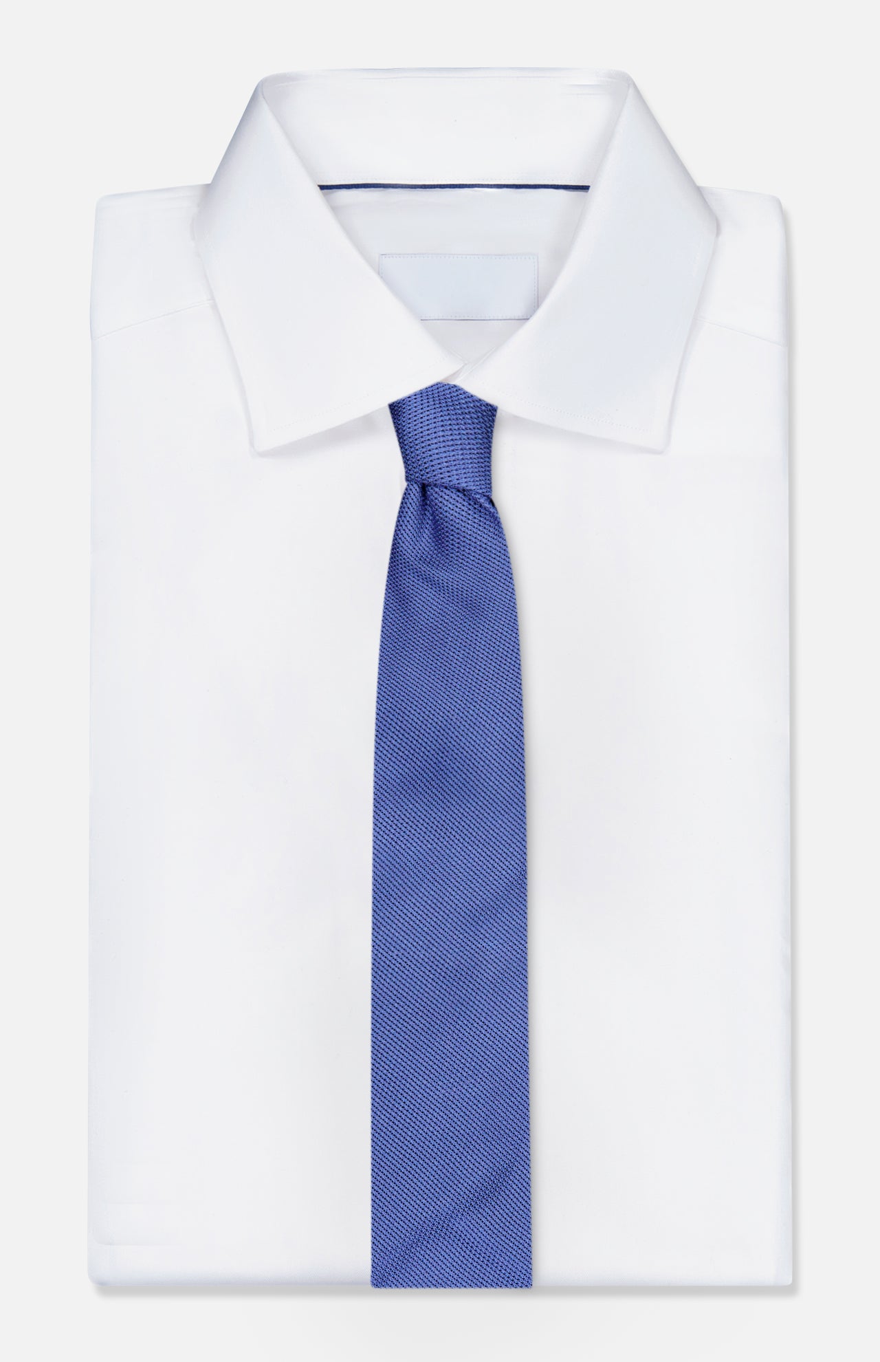 A crisp white dress shirt with a pointed collar is styled with the ROBERT TALBOTT Duvall Grenadine Unlined Tie in blue, set against a white background.