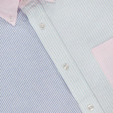 Close-up of the ROBERT TALBOTT Harrison Fun Stripe Oxford Dress Shirt, a cotton button-down with vertical blue, green, and pink pastel stripes, pink collar and pocket, white buttons, and a partially visible label near the collar.