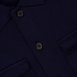 Close-up of the Landon Sweater Jacket by ROBERT TALBOTT, a navy blue button-up shirt-style jacket featuring a collar, two flap pockets, and a blue label reading Robert Talbott California. Crafted in a tailored fit, this hybrid sweater-jacket blends classic design with modern versatility.