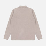 A beige Landon Sweater Jacket by ROBERT TALBOTT is displayed from the back, laid flat on a white background. The jacket features a collar and a simple, minimalistic design with no visible patterns or details, crafted from soft Merino wool for added comfort and sophistication.