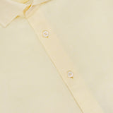 A close-up of the butter yellow Reynolds Contemporary Cotton Linen Dress Shirt by ROBERT TALBOTT, featuring a blue label inside the collar and white buttons on the front placket.