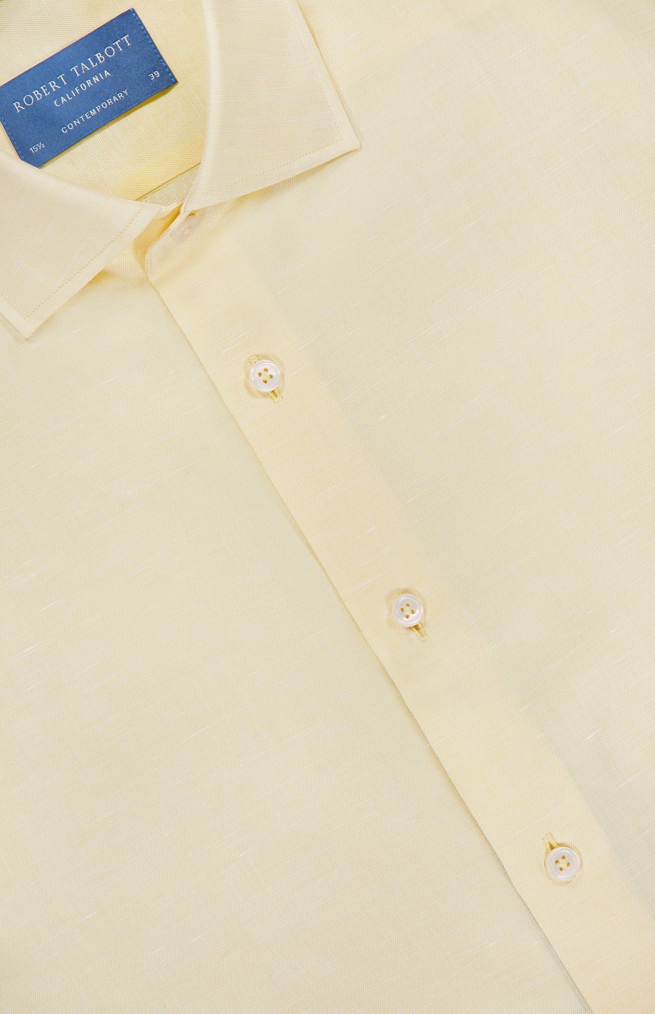 A close-up of the butter yellow Reynolds Contemporary Cotton Linen Dress Shirt by ROBERT TALBOTT, featuring a blue label inside the collar and white buttons on the front placket.