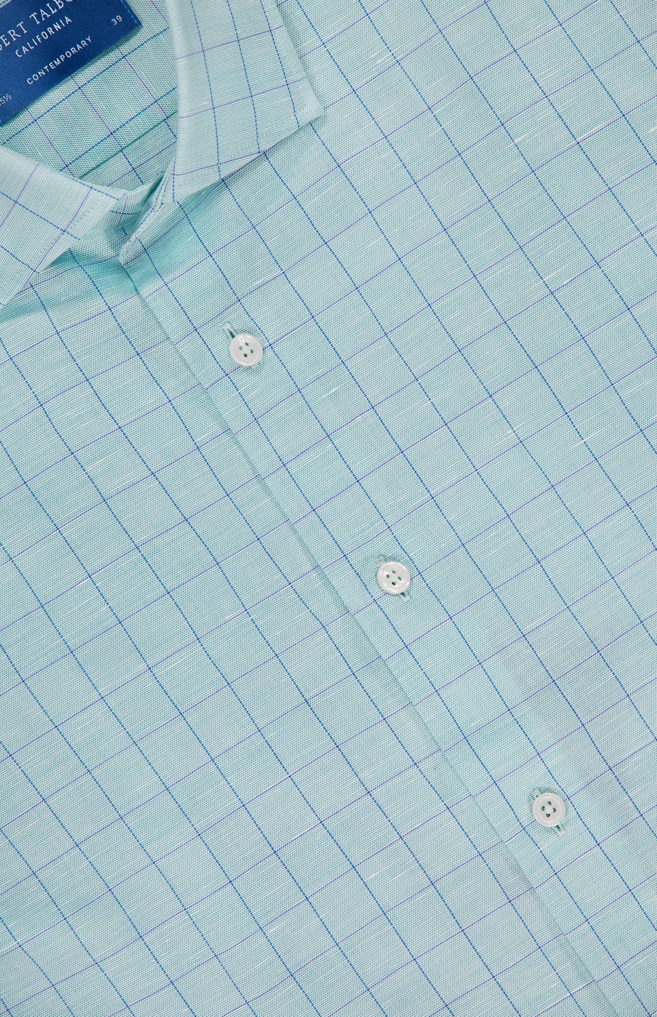 Close-up of the ROBERT TALBOTT Reynolds Windowpane Cotton Linen Dress Shirt, featuring light blue fabric with a fine blue windowpane pattern, white buttons, a collar, and a visible label inside the neckline.