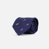 A navy silk tie featuring small, colorful embroidered fishing fly motifs—including playful and vibrant designs—rolled up on a plain white background, the Robert Fishing Flies Tie by ROBERT TALBOTT brings a whimsical twist to classic men’s luxury style.