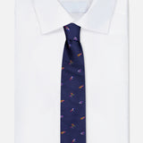 A neatly folded white dress shirt with the ROBERT TALBOTT Robert Fishing Flies Tie, a navy silk accessory adorned with a playful fishing flies pattern, displayed against a light background.