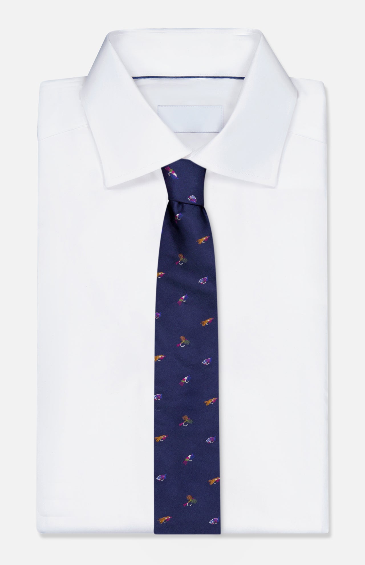 A neatly folded white dress shirt with the ROBERT TALBOTT Robert Fishing Flies Tie, a navy silk accessory adorned with a playful fishing flies pattern, displayed against a light background.