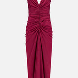 The Anya Ruched Maxi Dress by RONNY KOBO is a sleeveless magenta v-neck dress with thin straps, ruched bodice and waist detailing, and a draped, fitted maxi-length skirt.