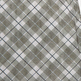 A close-up of the Azana Mesh Plaid Skirt by RONNY KOBO shows its gray, light blue, and white plaid pattern in a diagonal grid—ideal for stylish office wear. The fabric is slightly folded at the upper right.