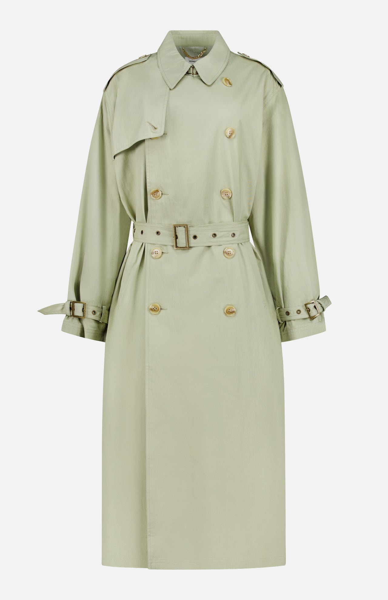The Cohen Oversized Raincoat by RONNY KOBO is a light sage green, trench-inspired coat featuring a belted waist, double-breasted front with gold buttons, shoulder epaulets, and buckled cuff straps, shown on a plain white background.