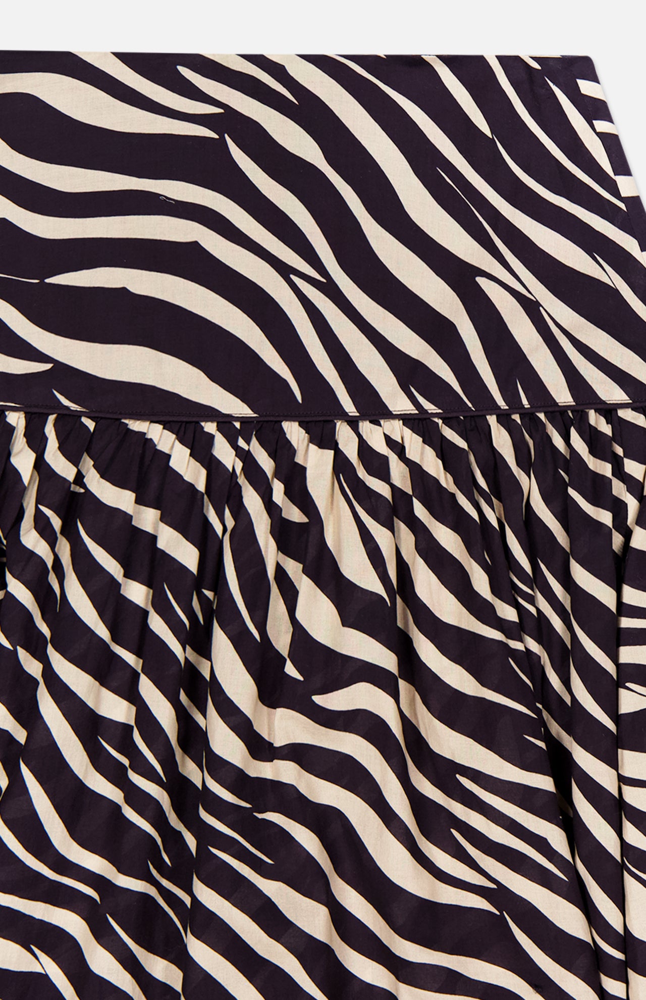Close-up of the Feyre Animal Print Skirt by RONNY KOBO, featuring bold black and white zebra stripes. The image showcases the gathered design with a visible waistband at the top.