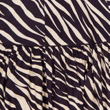 Close-up of the Feyre Animal Print Skirt by RONNY KOBO, showcasing bold black and cream zebra stripes with gathered pleats that highlight its striking animal print fabric.
