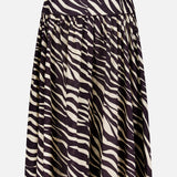 The Feyre Animal Print Skirt by RONNY KOBO features bold black and white zebra stripes, a knee-length gathered flared silhouette, and a fitted waistband for a striking animal print look.
