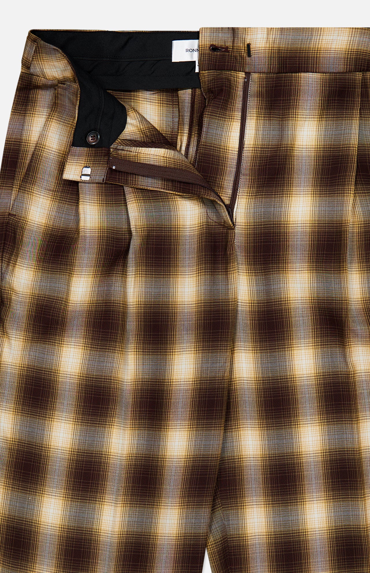 The Hayes Plaid Straight Leg Pant by RONNY KOBO features brown, yellow, and beige plaid with a soft gradient check pattern. Partially open at the waistband and fly to reveal the inside button and zipper closure, these tailored trousers offer a straight-leg silhouette for a timeless look.