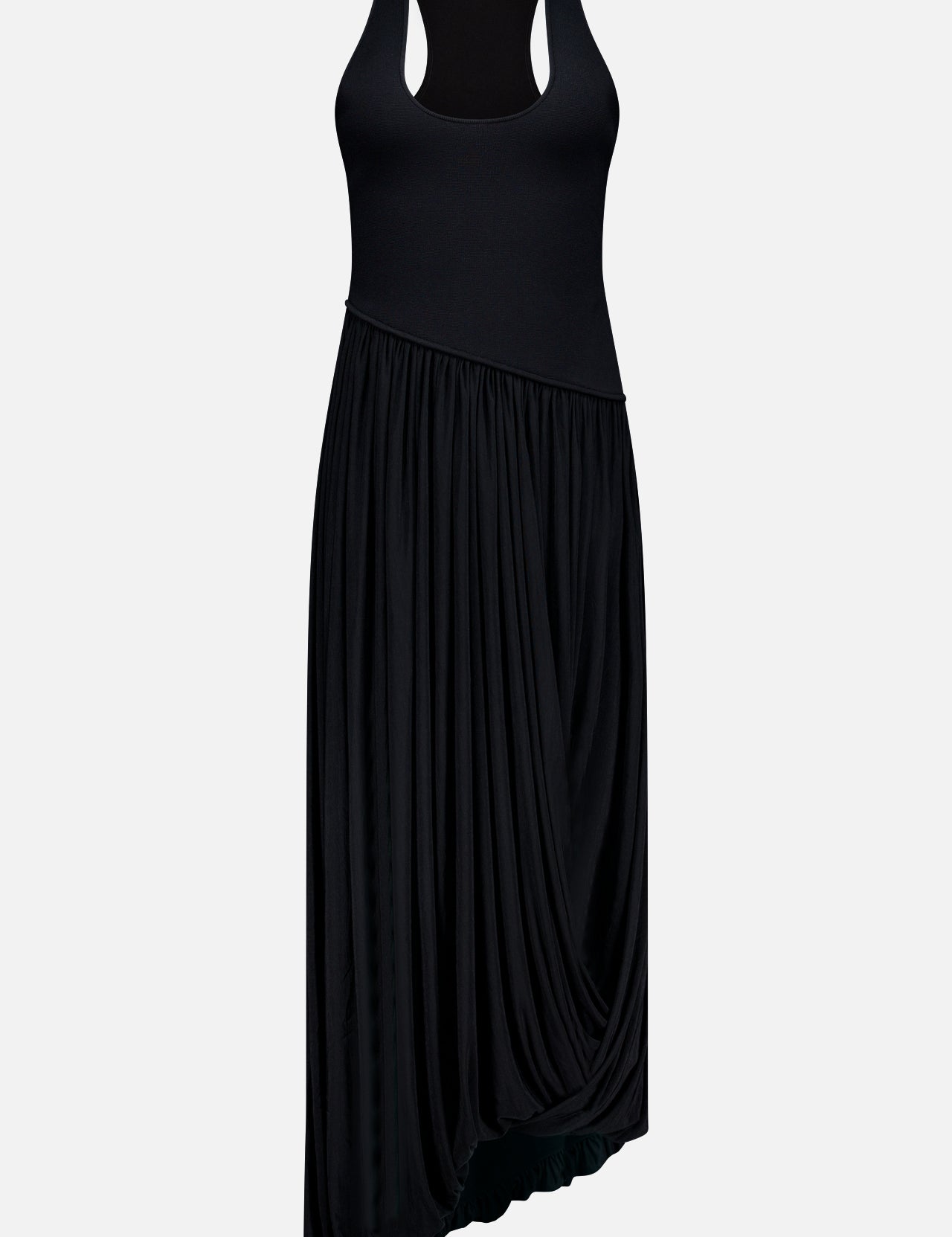 The Meyer Draped Hemline Dress by RONNY KOBO is a minimalist black dress with a sleeveless fitted bodice, racerback, and asymmetrical draped skirt. Shown on a plain white background for an elegant, flowy look.