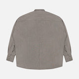 The Niall Stripe Pocket Top by RONNY KOBO is displayed from the back, featuring long sleeves with buttoned cuffs, a straight hem, and a slightly loose, boxy fit. Crafted from subtly textured fabric in grey stripes, this blouse is perfect for versatile workwear. The shirt is laid flat against a white background.