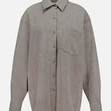 The Niall Stripe Pocket Top by RONNY KOBO is a versatile workwear essential featuring subtle vertical stripes, a collar, long sleeves, and a front left chest pocket. This striped button-down shirt is displayed against a plain white background.