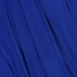 A close-up of smooth blue fabric with soft folds and gentle draping, inspired by the Rhodes Draped Maxi Dress from RONNY KOBO, highlighting movement and textured elegance.