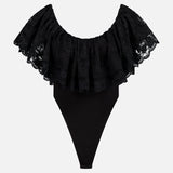 The RONNY KOBO Rosette Lace Detail Bodysuit is a black off-the-shoulder piece with wide, layered lace trim and a fitted bottom—perfect as a going-out top, shown against a plain white background.