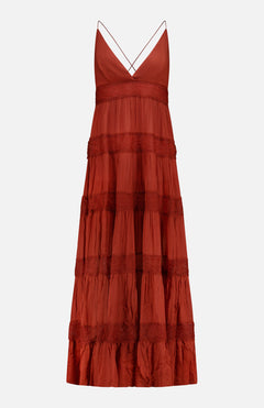 The Rune Lace Panel Maxi Dress by RONNY KOBO is a sleeveless rust maxi dress with a deep V-neck, spaghetti straps, tiered ruffled lace panels, and a flowy bohemian style, shown against a plain white background.