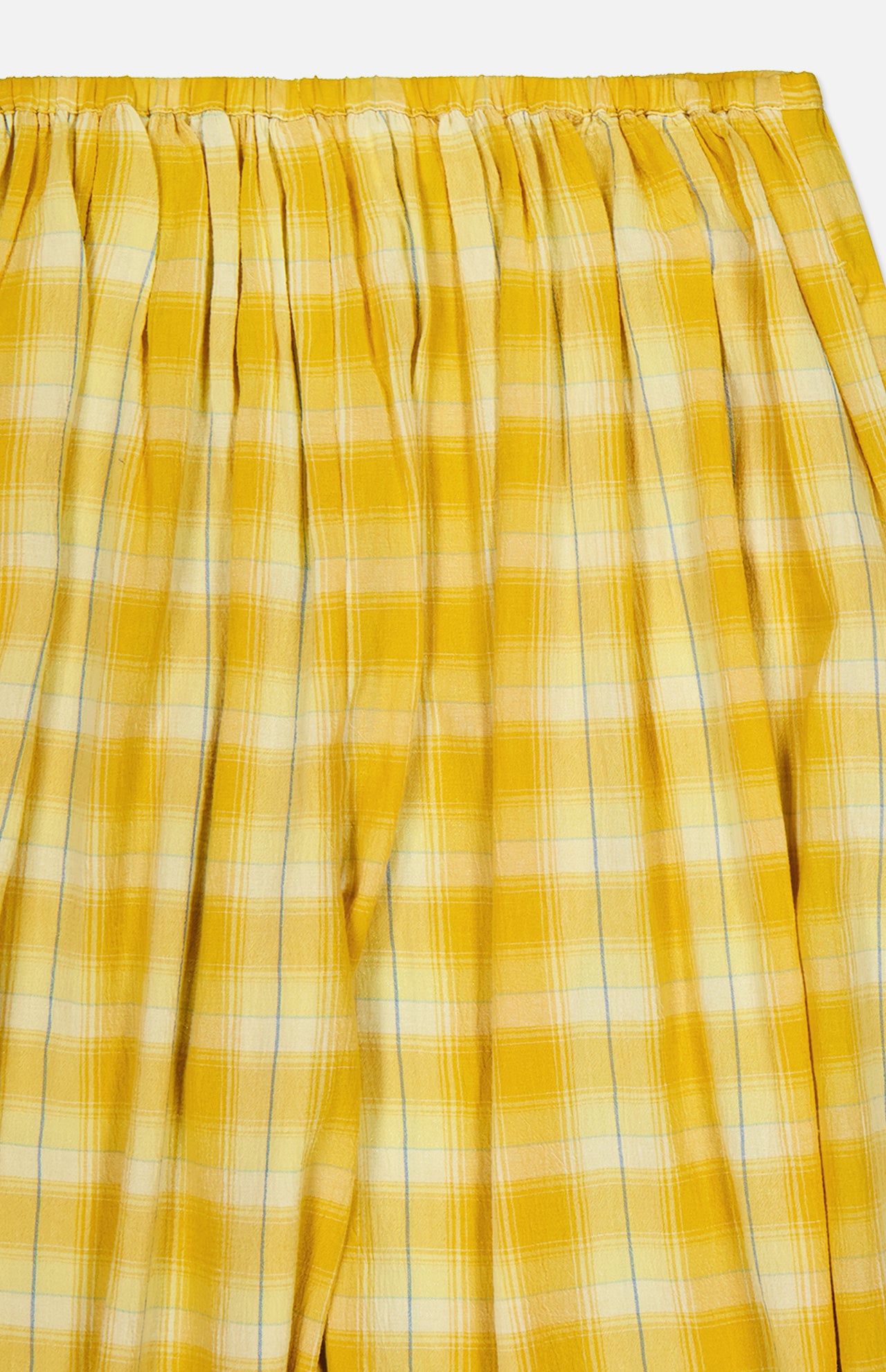 Close-up of yellow plaid fabric featuring white and subtle blue stripes, gathered at the top with pleats—a stylish detail from the Ryker Plaid Balloon Pant by RONNY KOBO.