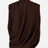The Sav Draped Sleeveless Top by RONNY KOBO is a chocolate brown going-out piece featuring a high neckline and sleeveless design. Its gathered, draped fabric creates soft folds and a voluminous silhouette, giving the top a sculptural and sophisticated look against any plain background.