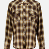 The Tatie Plaid Western Shirt by RONNY KOBO features a brown and yellow plaid pattern, long sleeves, a pointed collar, and two front chest pockets. Displayed on a plain white background, this classic western blouse is the perfect fall fashion top to elevate your wardrobe.