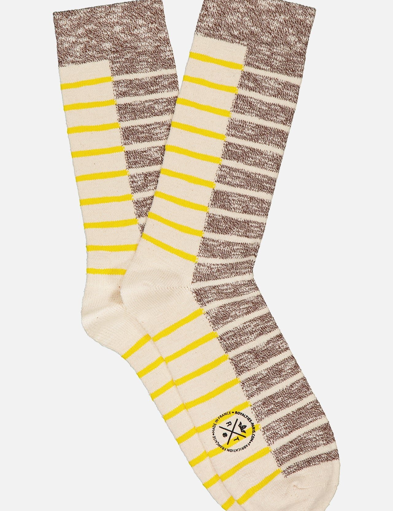 The Horatio Sock by ROYALTIES features tan fabric with cream, yellow, and brown horizontal stripes, brown heels, toes, and cuffs, and a small circular logo near the toe on one sock.
