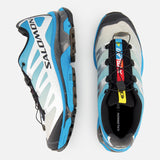 A pair of SALOMON XT-4 OG Sneakers in blue, grey, and black with a quicklace system and EnergyCell midsole, displayed from side and top views on a white background.