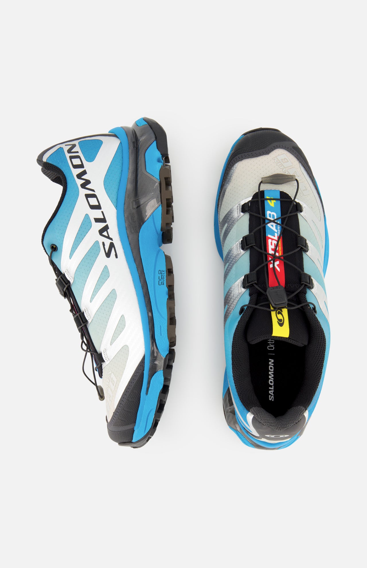 A pair of SALOMON XT-4 OG Sneakers in blue, grey, and black with a quicklace system and EnergyCell midsole, displayed from side and top views on a white background.