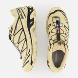 The SALOMON XT-6 GTX Sneaker in beige features black accents, rainbow lace loop details, a quick lace system, and SALOMON branding on the side and tongue. Shown from side and top view on a white background.