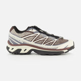 The SALOMON XT-6 Shadow Sneaker, displayed in brown, black, and beige from a side view, features a textured upper, quick-lace system, enhanced cushioning, and a rugged sole engineered for durability in outdoor pursuits.