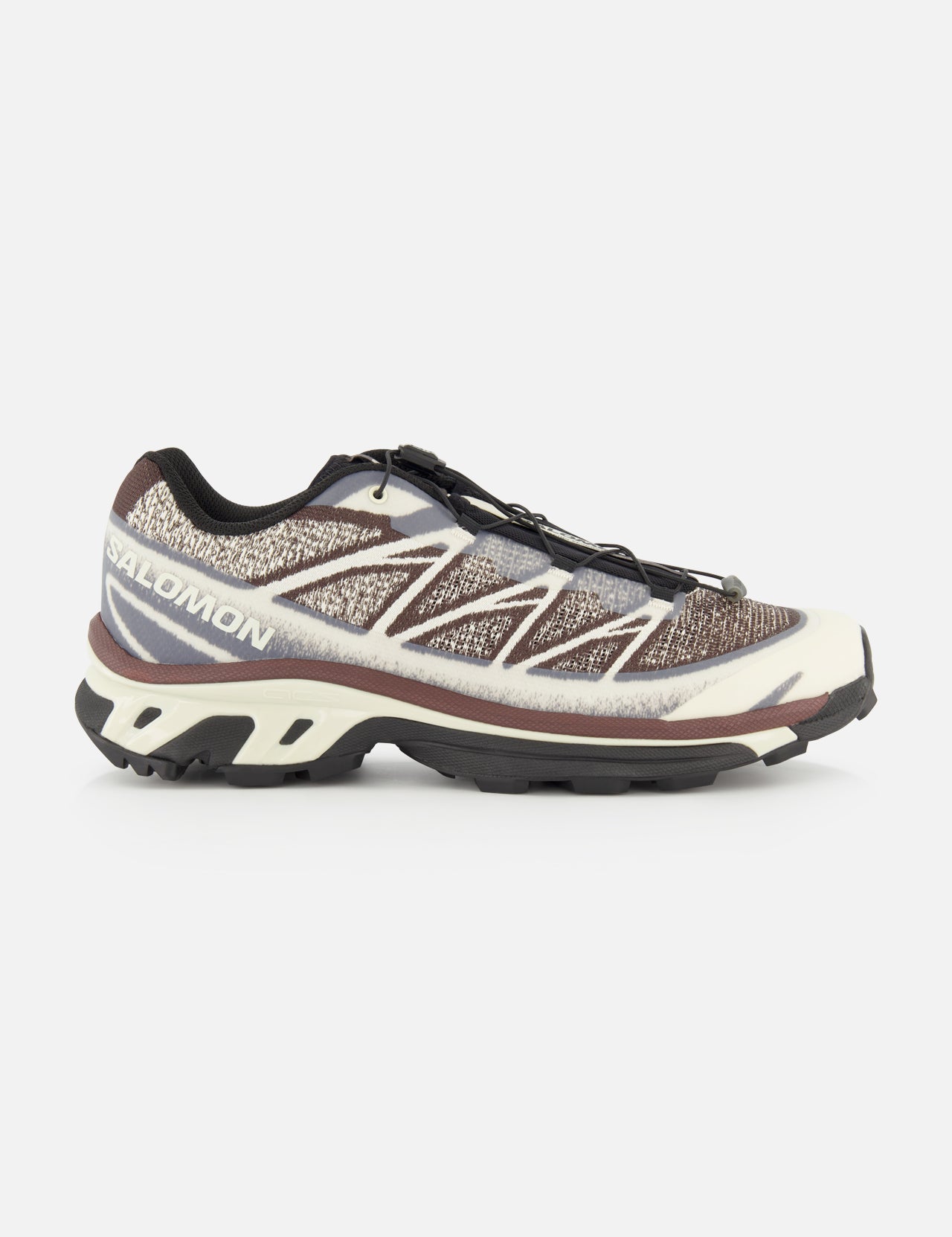 The SALOMON XT-6 Shadow Sneaker, displayed in brown, black, and beige from a side view, features a textured upper, quick-lace system, enhanced cushioning, and a rugged sole engineered for durability in outdoor pursuits.