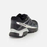 A black and gray SALOMON XT-Pathway GTX Sneaker with a quick lace system is shown from the back and side, highlighting the heel, sole, and side logo against a white background.