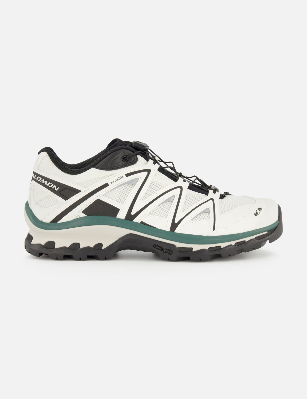 Side view of the SALOMON XT-Quest Sneaker in white and black, featuring a rugged black sole, green-gray accents, and lace-up closure; this hybrid performance sneaker is designed to blend urban wearability with enhanced stability and grip, shown against a plain white background.