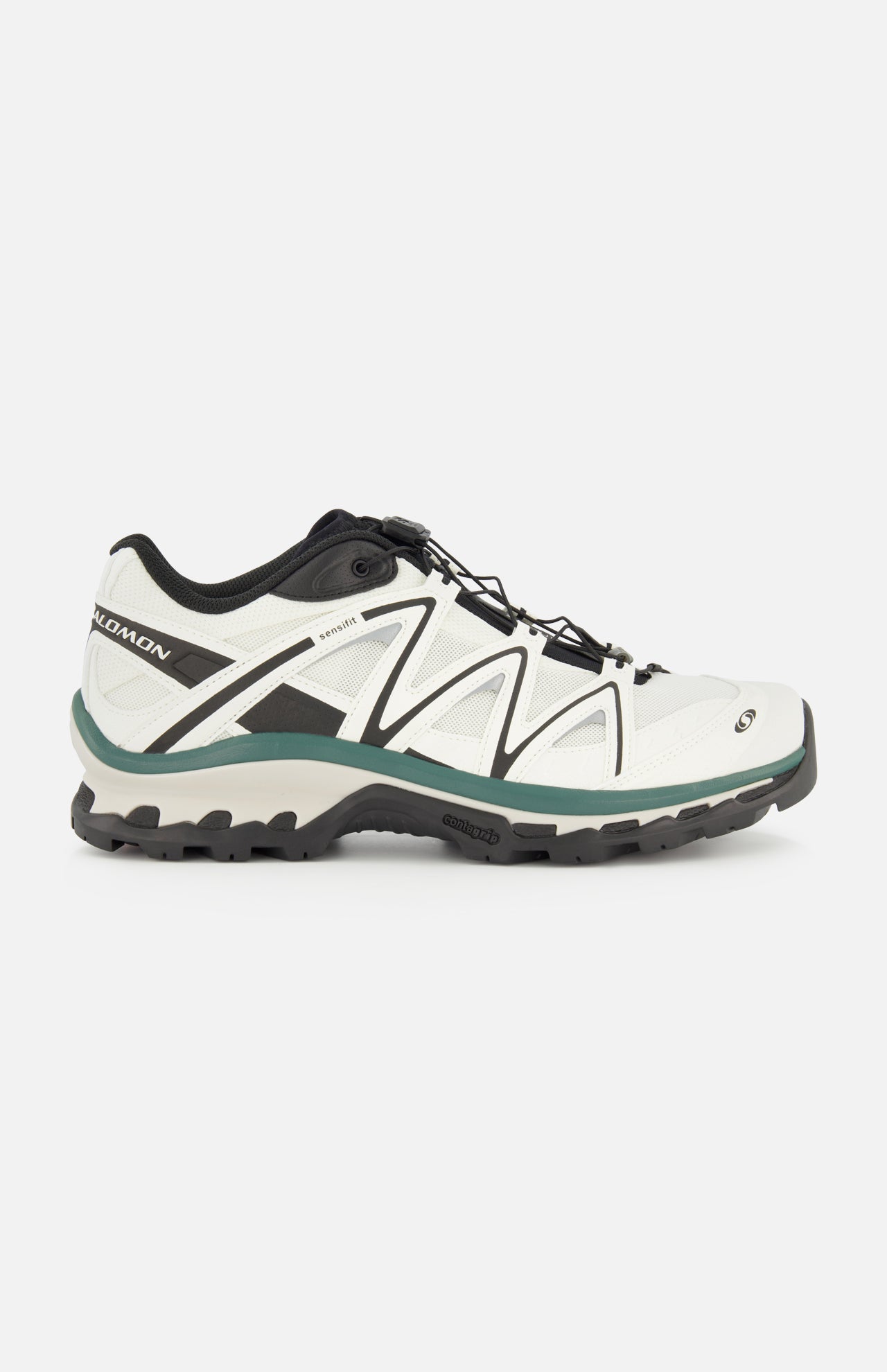Side view of the SALOMON XT-Quest Sneaker in white and black, featuring a rugged black sole, green-gray accents, and lace-up closure; this hybrid performance sneaker is designed to blend urban wearability with enhanced stability and grip, shown against a plain white background.