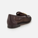 The SAM EDELMAN Loraine Mesh Equestrian-inspired Loafer is a dark brown shoe with a gold buckle bit, low black heel, and sheer mesh panel, shown from a rear side angle on a white background.