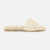 The Miya Woven Sandal by SAM EDELMAN is a beige raffia slide with a flat sole, open toe, and wide textured strap. Its casual, summery design makes it perfect for warm-weather days.