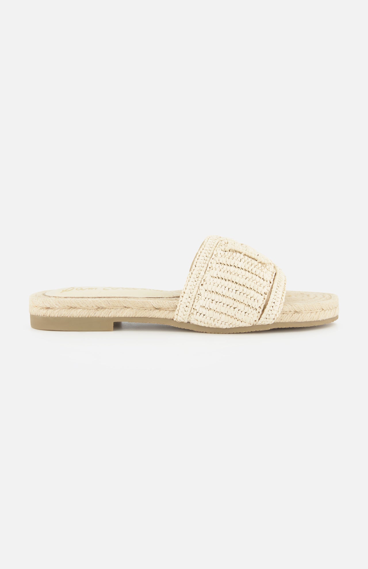 The Miya Woven Sandal by SAM EDELMAN is a beige raffia slide with a flat sole, open toe, and wide textured strap. Its casual, summery design makes it perfect for warm-weather days.