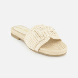 The Miya Woven Sandal by SAM EDELMAN features a beige raffia design with a flat sole and thick braided strap, making it an ideal summer sandal; shown here on a white background.