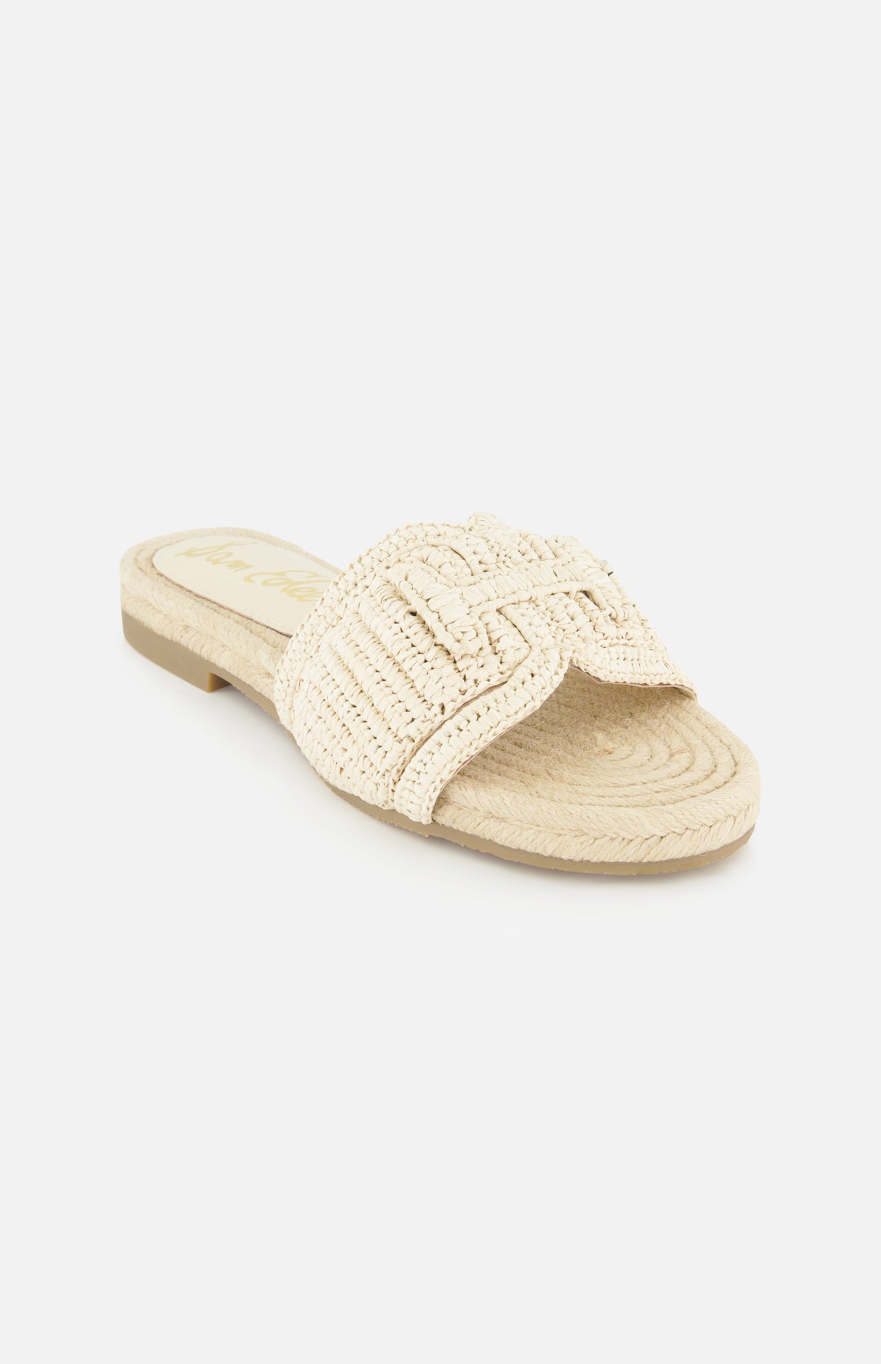 The Miya Woven Sandal by SAM EDELMAN features a beige raffia design with a flat sole and thick braided strap, making it an ideal summer sandal; shown here on a white background.