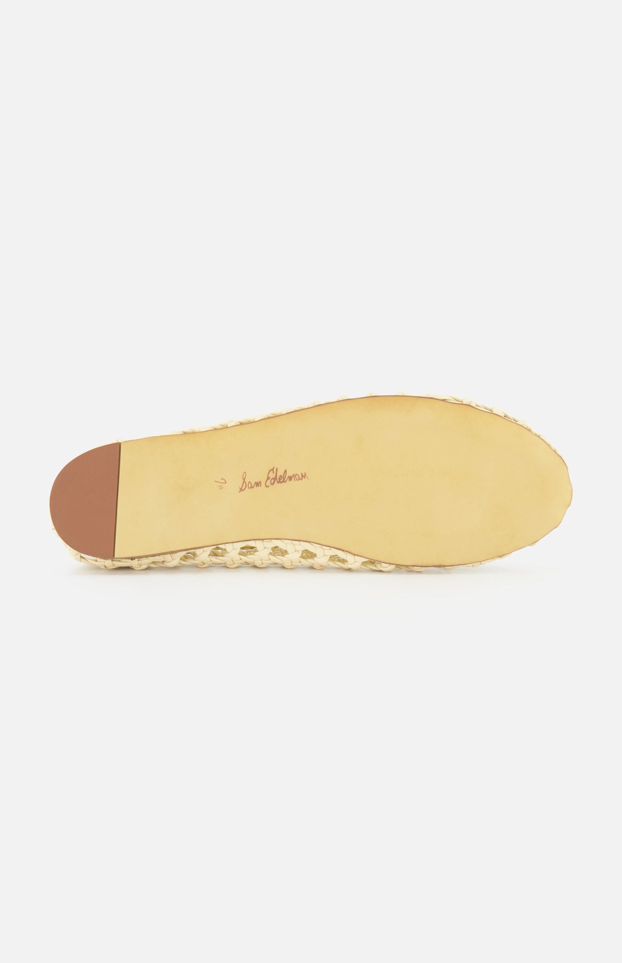 The image shows the bottom of the Shira Woven Leather Flat by SAM EDELMAN in beige off-white, with a square toe, small brown heel cap, "Sam Edelman" in cursive at the center, and a smooth sole edged with texture.