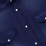 Close-up of a SARTORIO Distressed Cotton Button Up Shirt in dark blue, featuring snap buttons, two chest pockets, and a slight fabric sheen. The brand label appears at the collar.