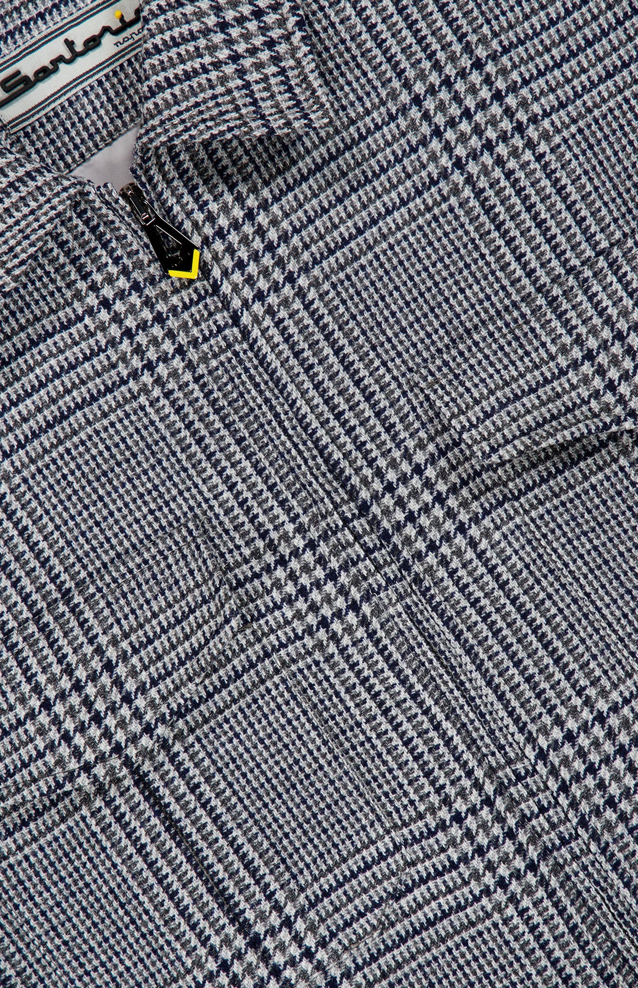 Close-up of a grey and navy Houndstooth Wool-blend Jacket by SARTORIO, featuring a zippered front.