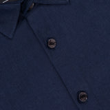 Close-up of the SARTORIO Linen Flap Pocket Overshirt in navy, showing two buttons and part of the label with "SARTORIO" in white text, made in Italy.