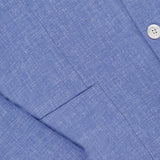 Close-up of a blue dress shirt with a subtle textured pattern and white buttons, ideal for pairing with the SARTORIO Virgin Wool Single-breasted Sportcoat.