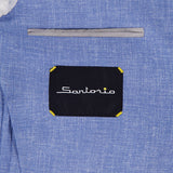 Close-up of the inside pocket of the Virgin Wool Single-breasted Sportcoat by SARTORIO in light blue, showing a black SARTORIO label with yellow corners below the welt pocket.