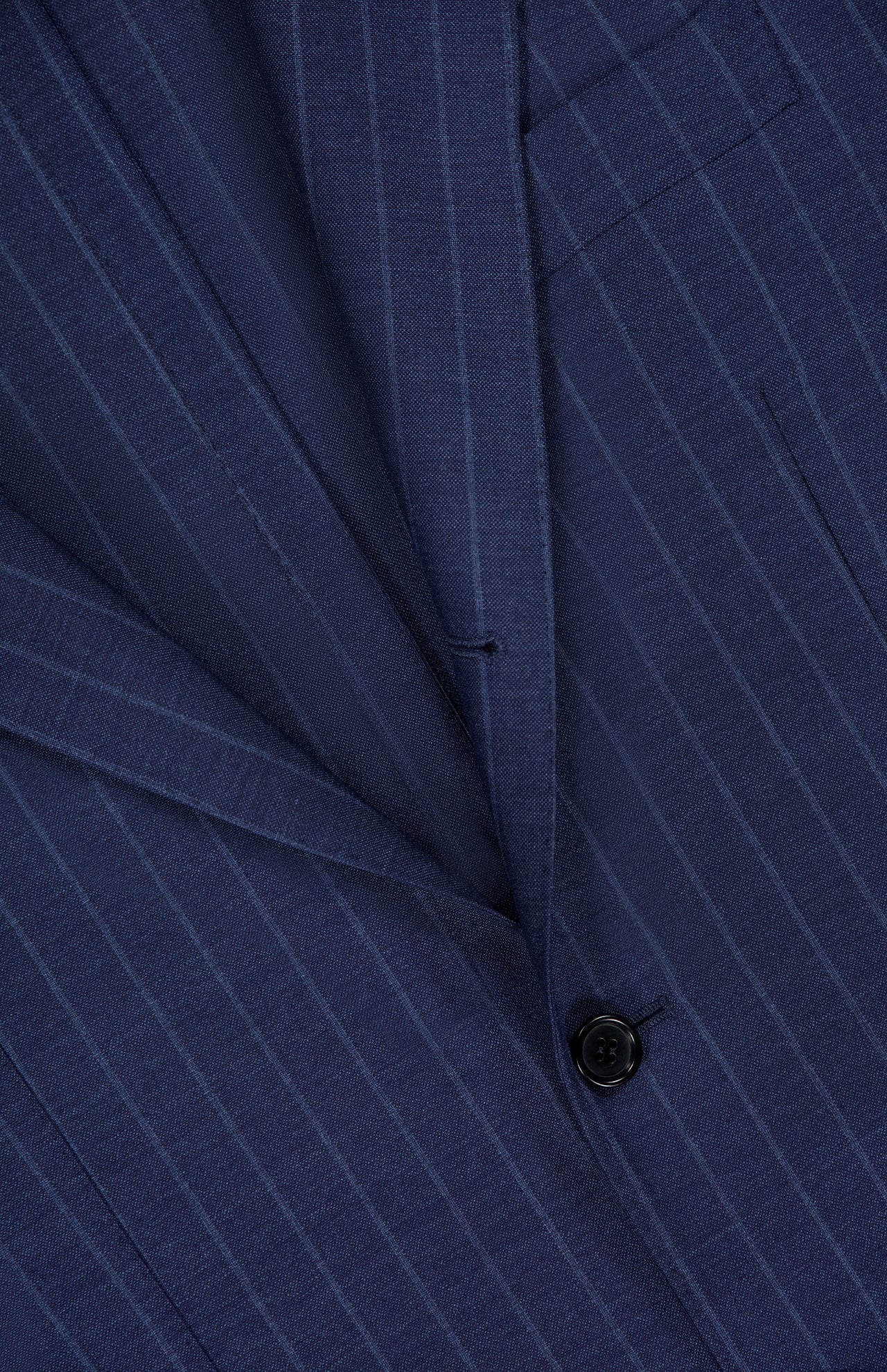 Close-up of the SARTORIO Pinstripe Wool Suit, featuring a navy jacket with light blue stripes, black button, pocket, lapel details, and crafted in Italy from premium virgin wool.