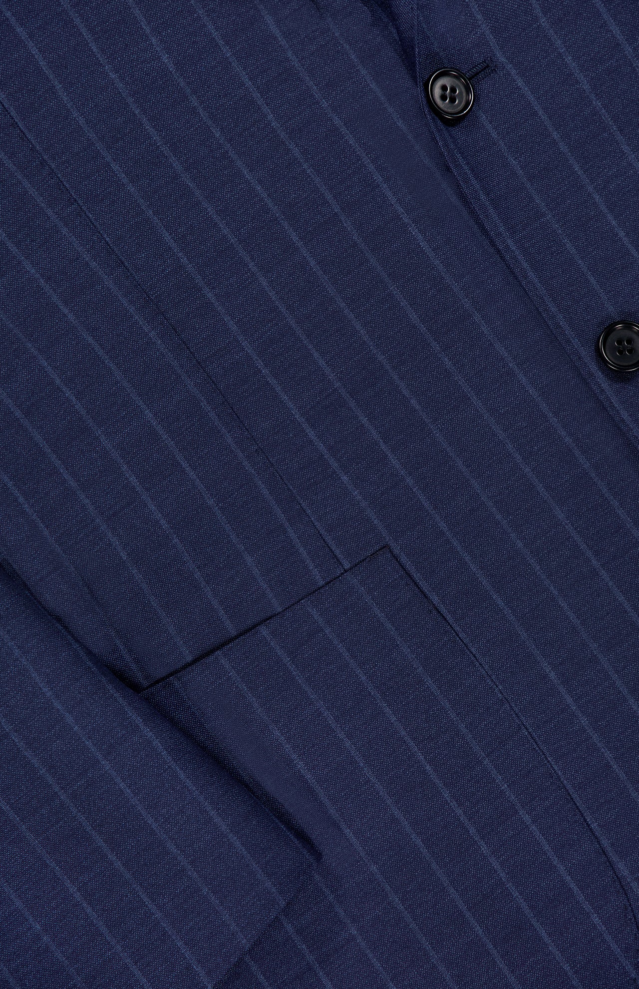 Close-up of the SARTORIO Pinstripe Wool Suit, crafted from virgin wool in Italy. Features classic navy pinstripes, black buttons, tailored details, and a visible lapel showcasing the fabric's refined texture.