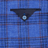 SARTORIO Wool Blend Plaid Sportcoat features blue and red plaid fabric, reminiscent of a classic blue plaid sportcoat, with a small dark blue triangular pocket flap secured by a light blue four-hole button near the center of the image.