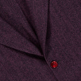 Close-up of the SARTORIO Wool Herringbone Sportcoat in a purple herringbone pattern, showcasing a stitched seam and two red buttons—an Italian-made tailored piece.
